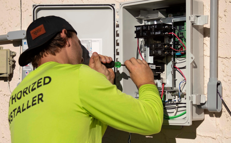 Technician testing circuits inside an electrical enclosure