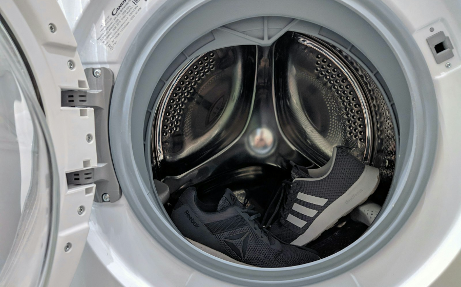 Front-load washing machine open in a home laundry