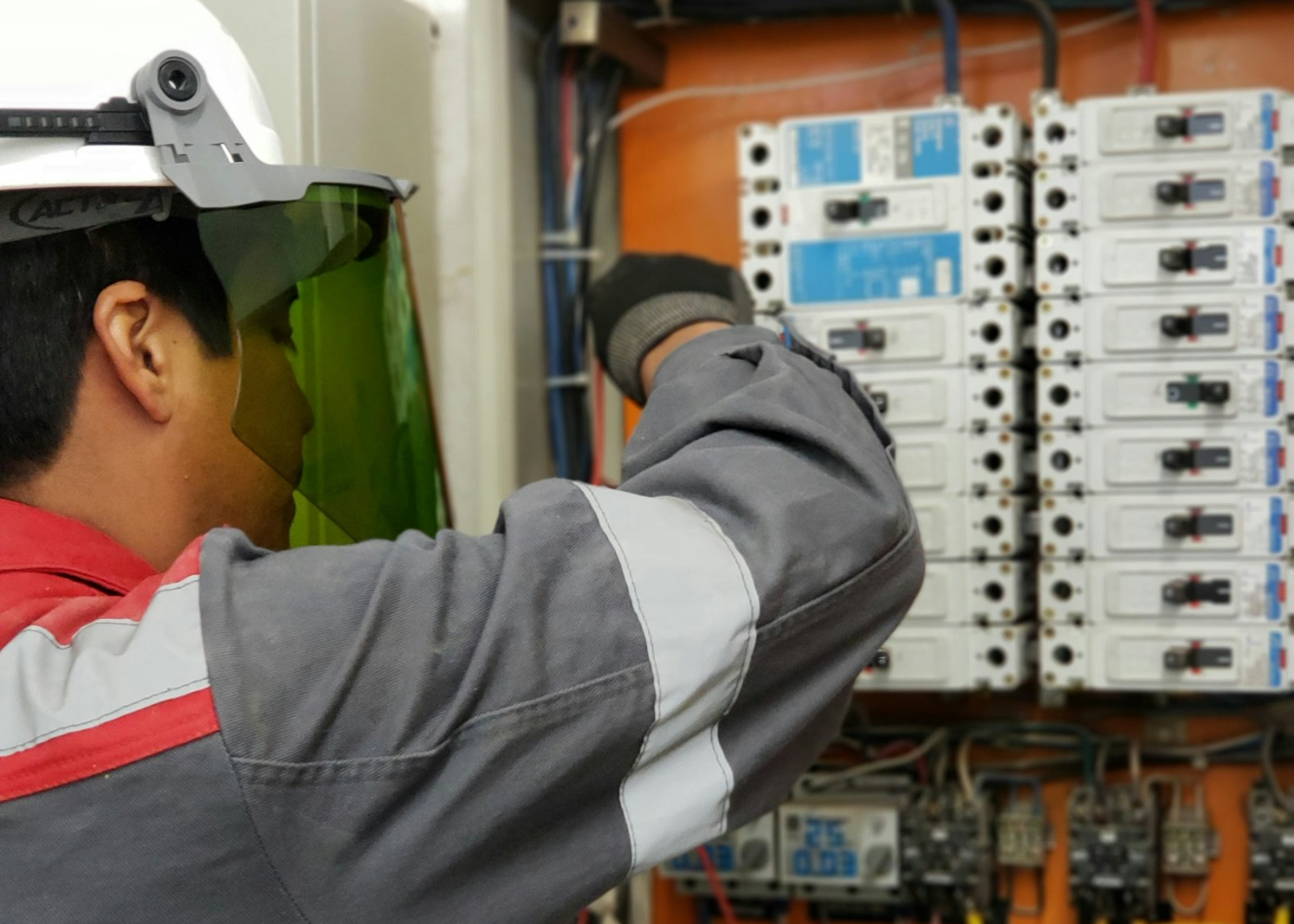 Electrician working inside a distribution board